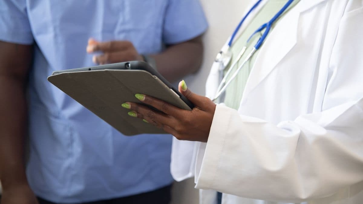 a doctor showing a patient something on the tablet